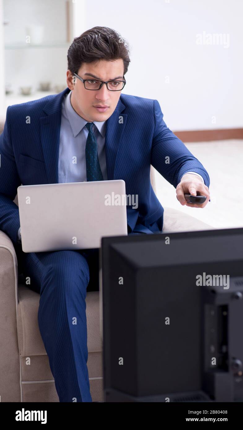 The businessman watching tv in the office Stock Photo Alamy