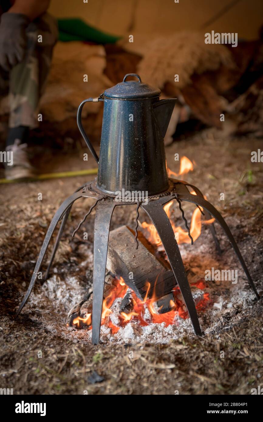 Campfire, old coffee pot on the fire hires stock photography and