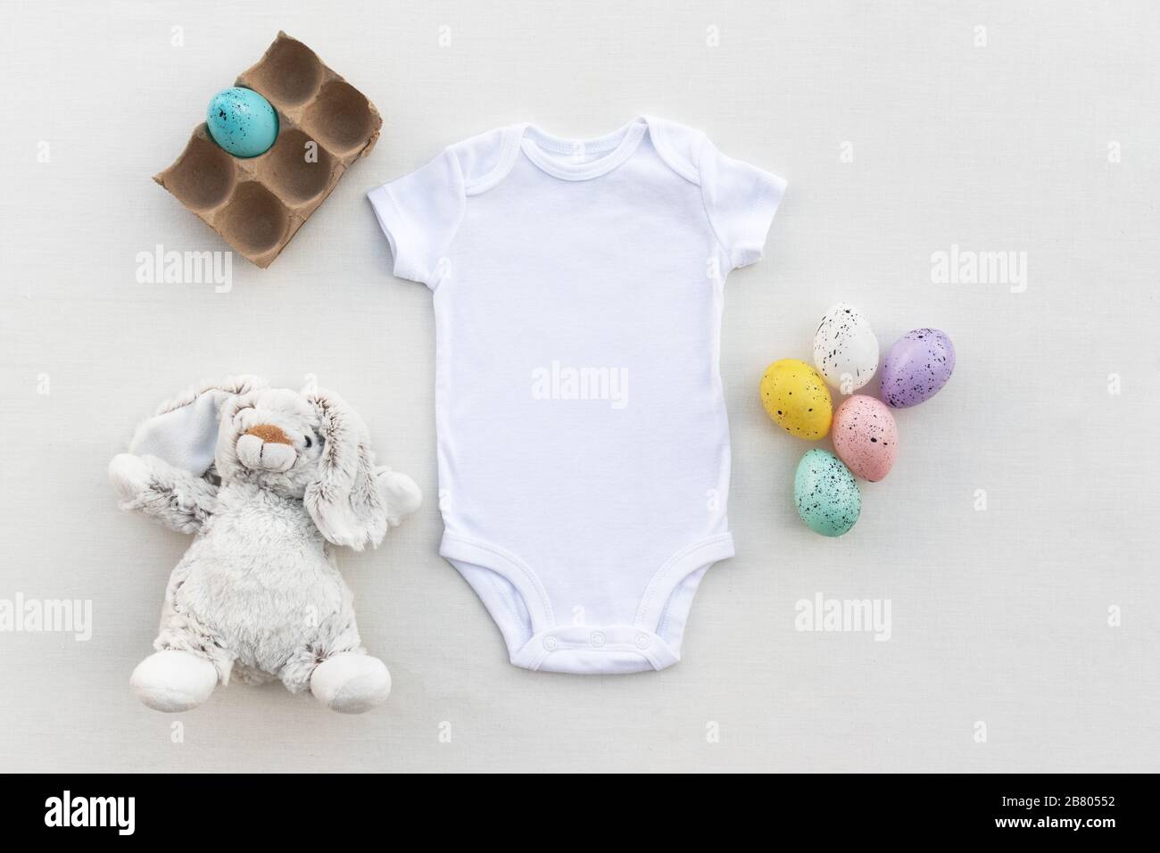 Easter baby bodysuit mockup - Newborn baby vest Easter themed flat lay mock up Stock Photo