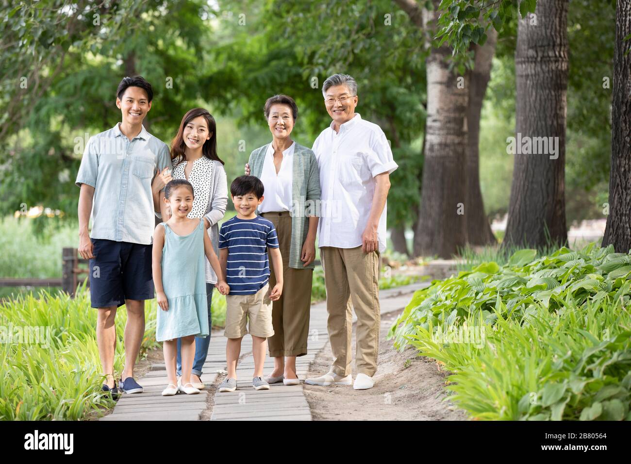 Happy Chinese family relaxing in park Stock Photo - Alamy
