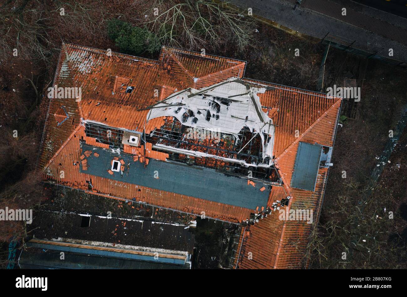 roof of house damaged by heavy hurricane tornado storm Stock Photo