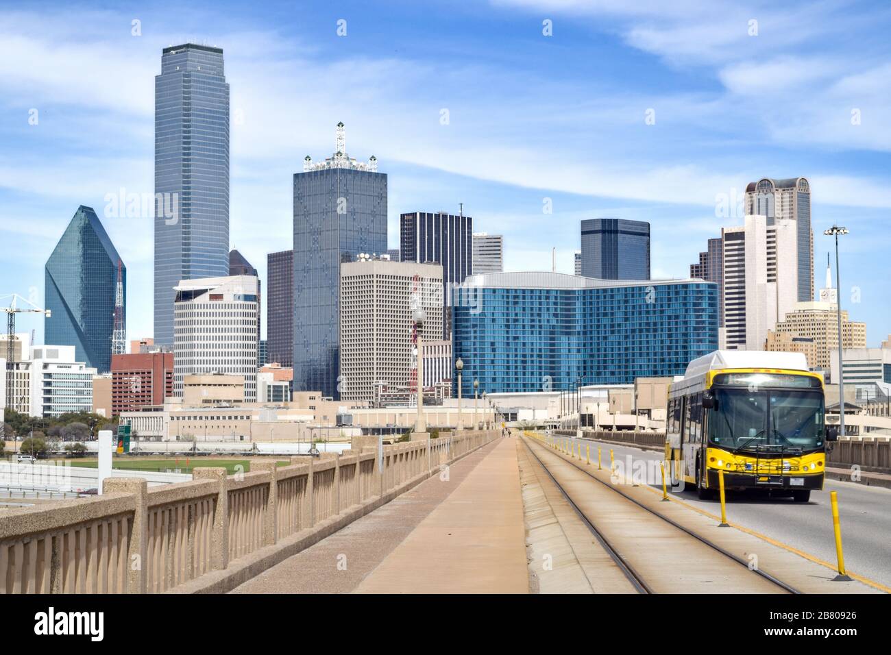 Public Bus on Elevated Highway with Downtown Dallas in the Background - Dallas, Texas, USA Stock Photo