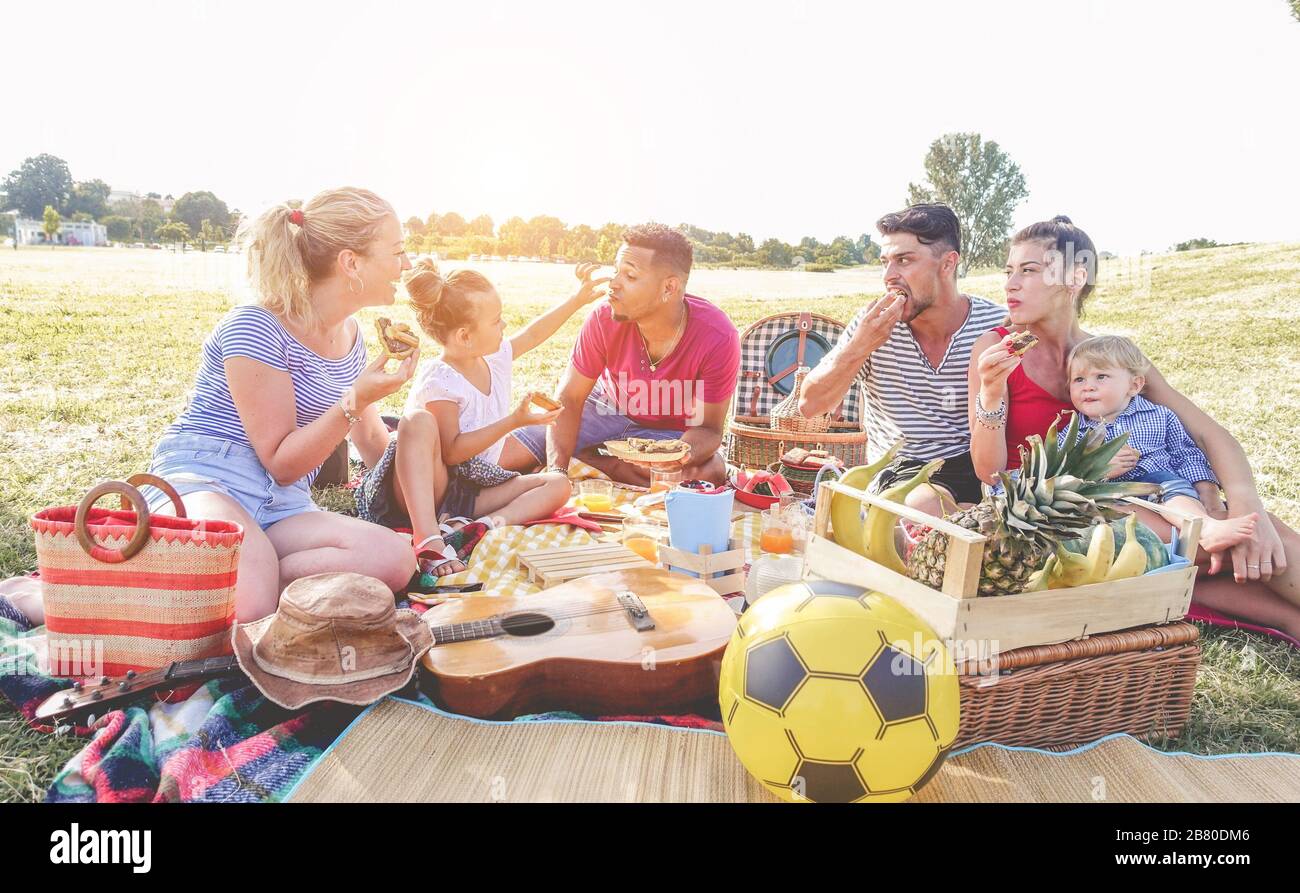 happy-families-making-picnic-in-city-park-young-parents-having-fun