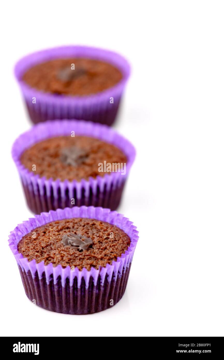 Chocolate muffins in a purple paper basket. Selective focus with shallow depth of field. Stock Photo
