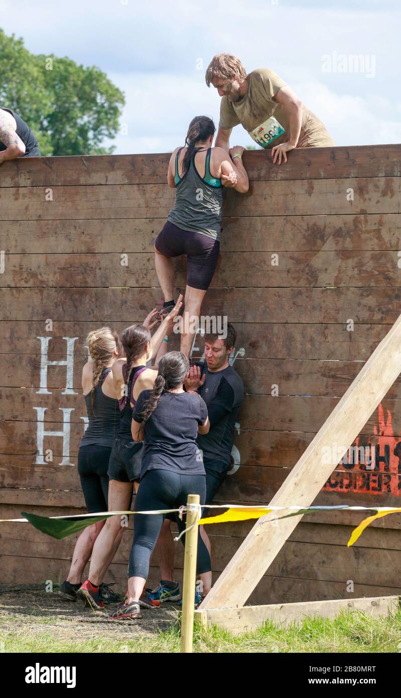 Tough Mudder Obstacle Course: participants tackling the Berlin Wall obstacle Stock Photo