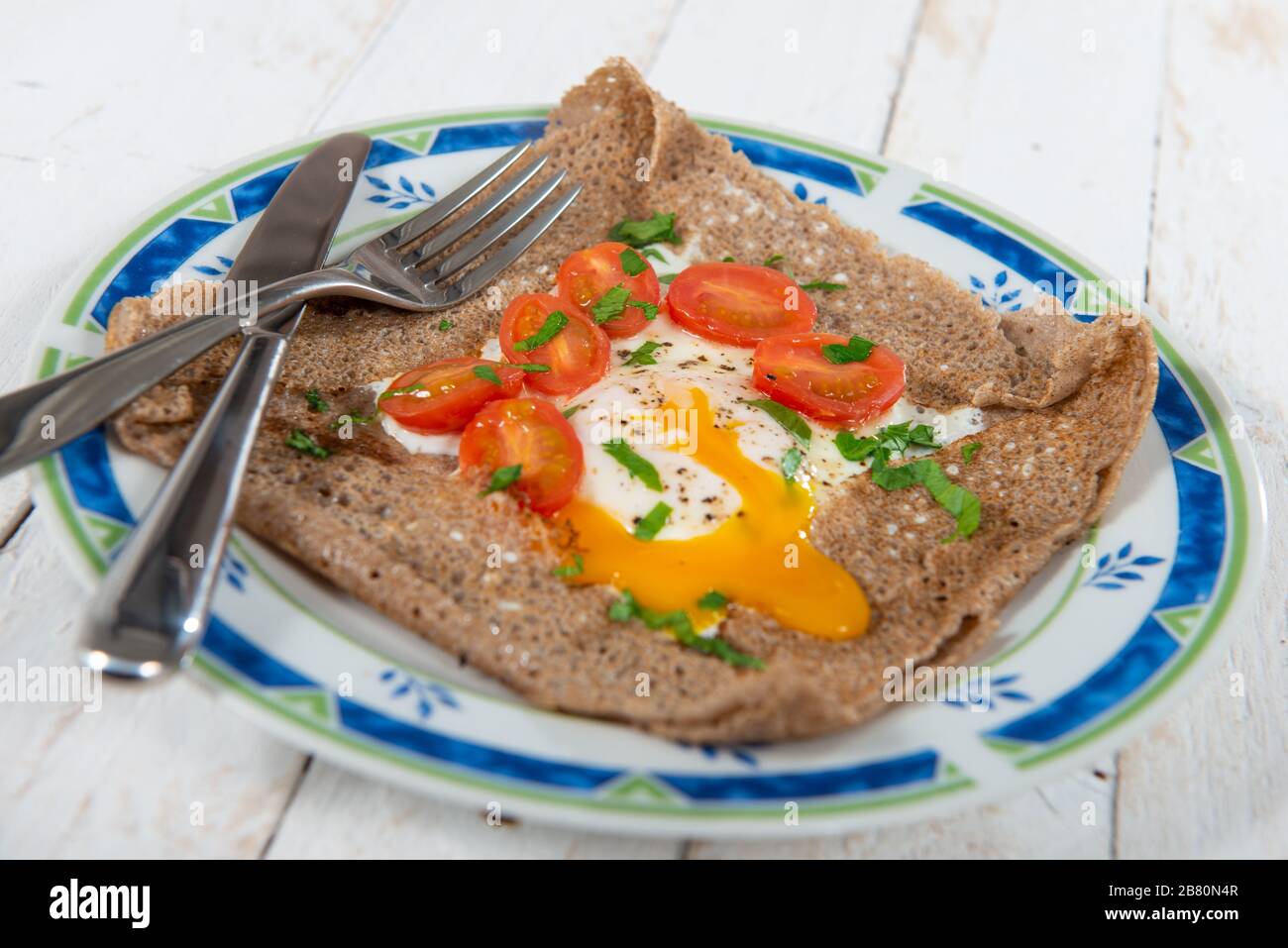 a Breton crepe with egg and tomatoes Stock Photo