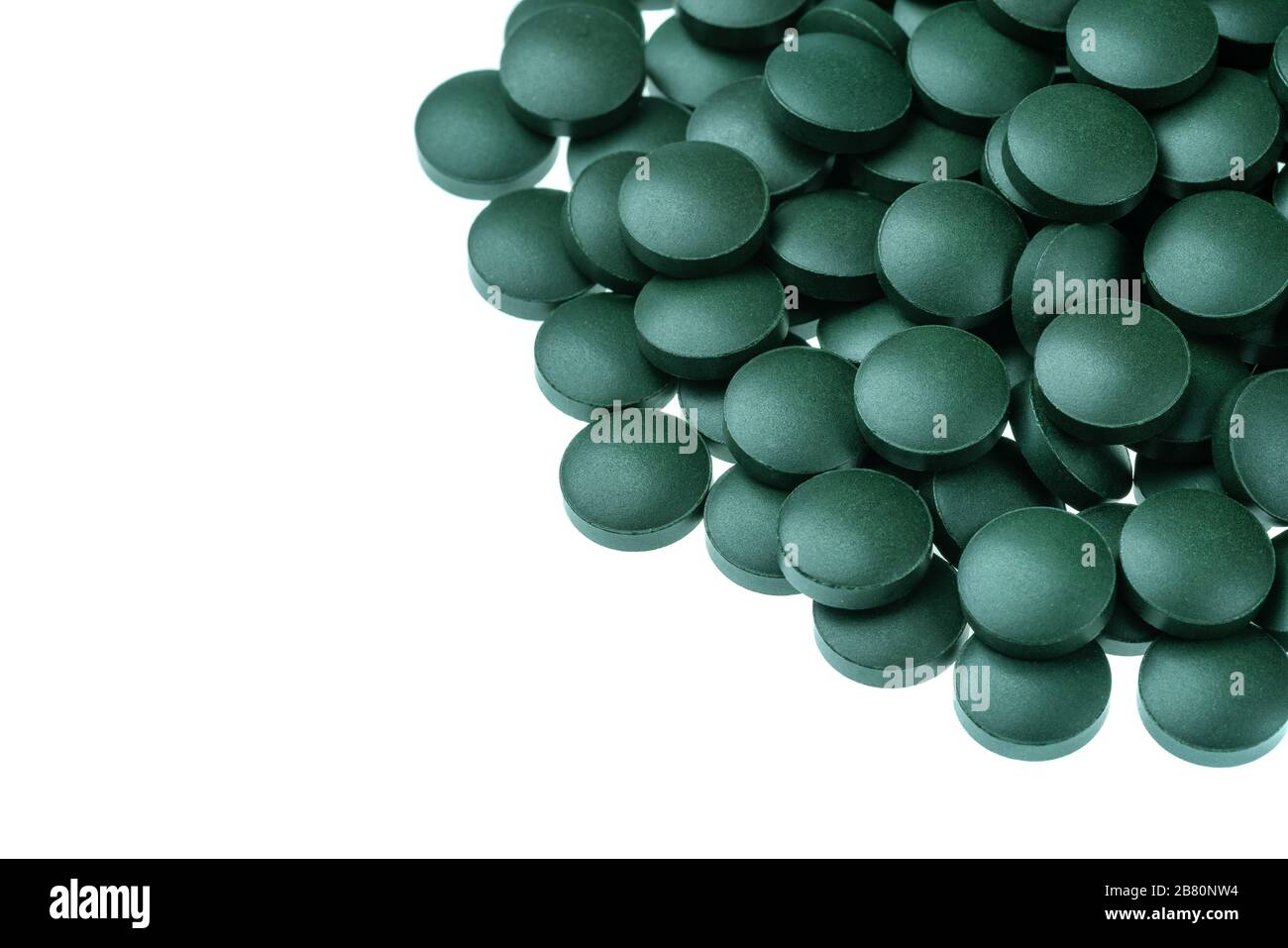 Vitamin and mineral supplements for vegetarians spirulina in tablets on a white background, close-up Stock Photo