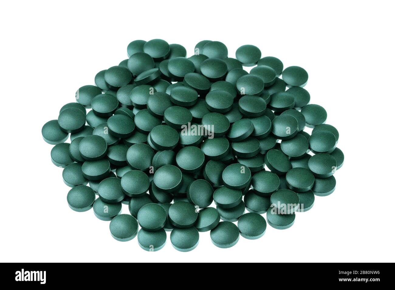 Vitamin and mineral supplements for vegetarians spirulina in tablets on a white background, close-up Stock Photo