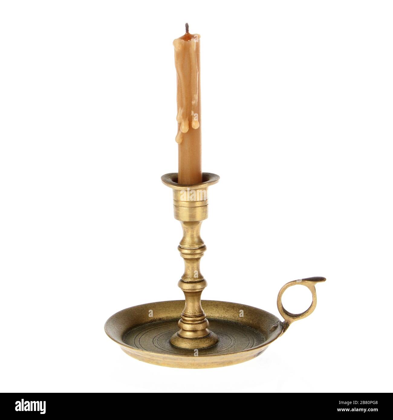 Candle on the old brass candlesticks on a white background Stock