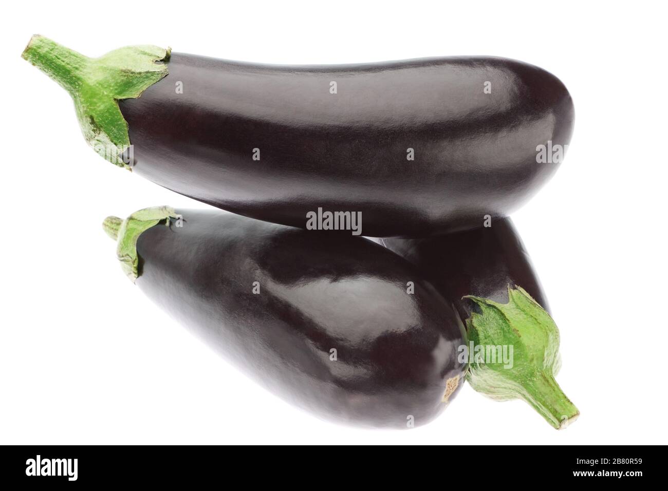 Three ripe eggplants in a heap. On a white background. Stock Photo