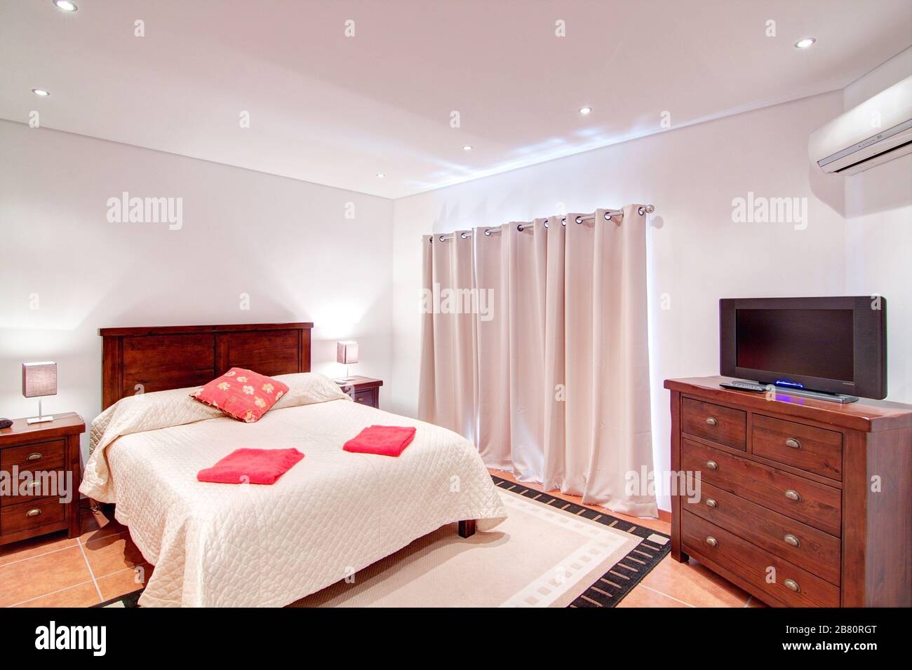 Bedroom for two people with a TV. In Decoration Stock Photo - Alamy