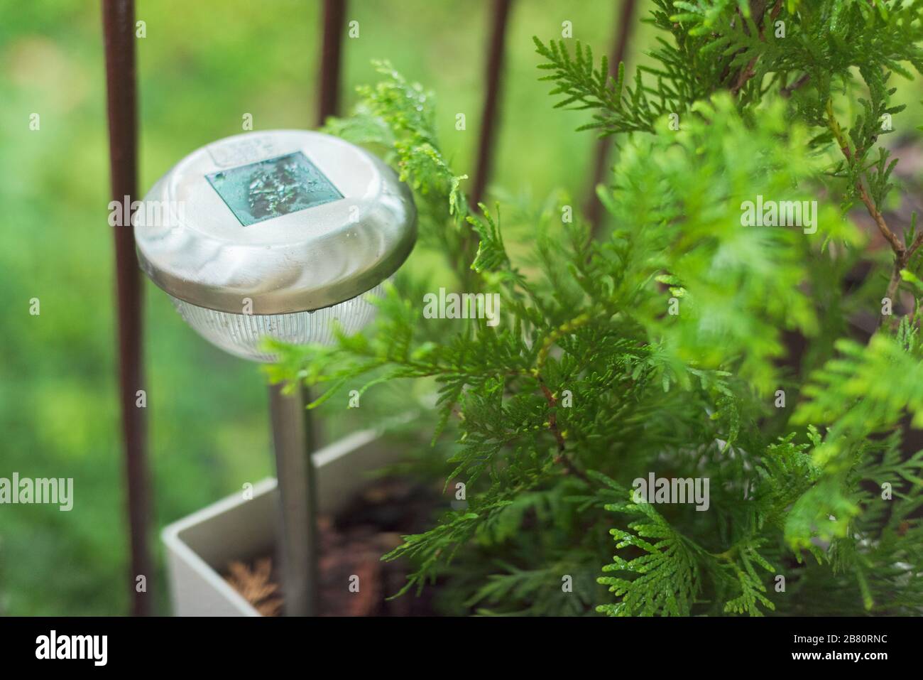 Lamp on the terrace in raindrops, garden lamp solar powered Stock Photo
