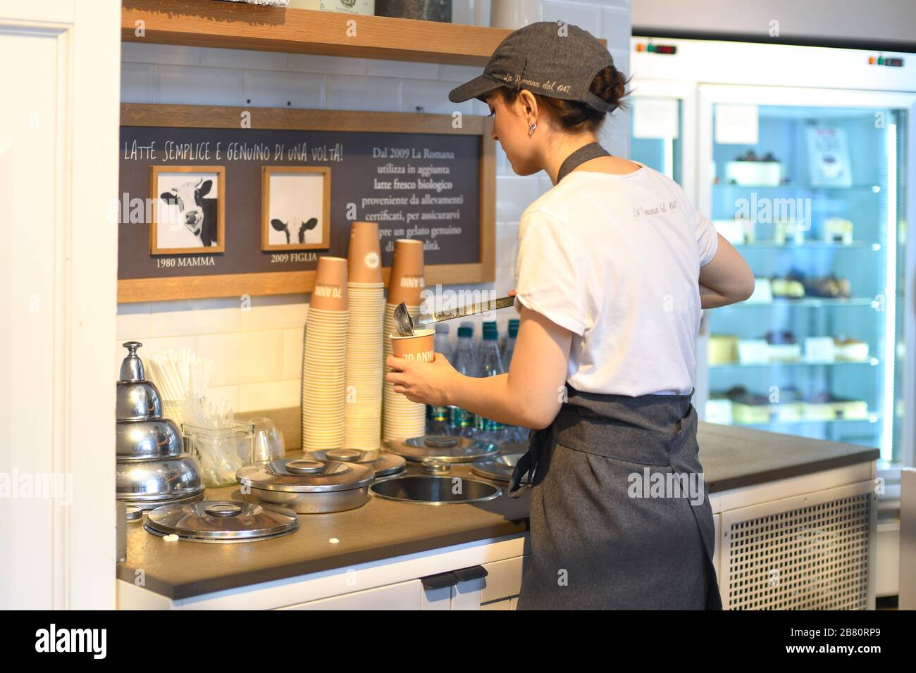VERONA, ITALY - AUGUST 16, 2019: A girl prepares a hot chocolate in the famous cafeteria La Romana Stock Photo