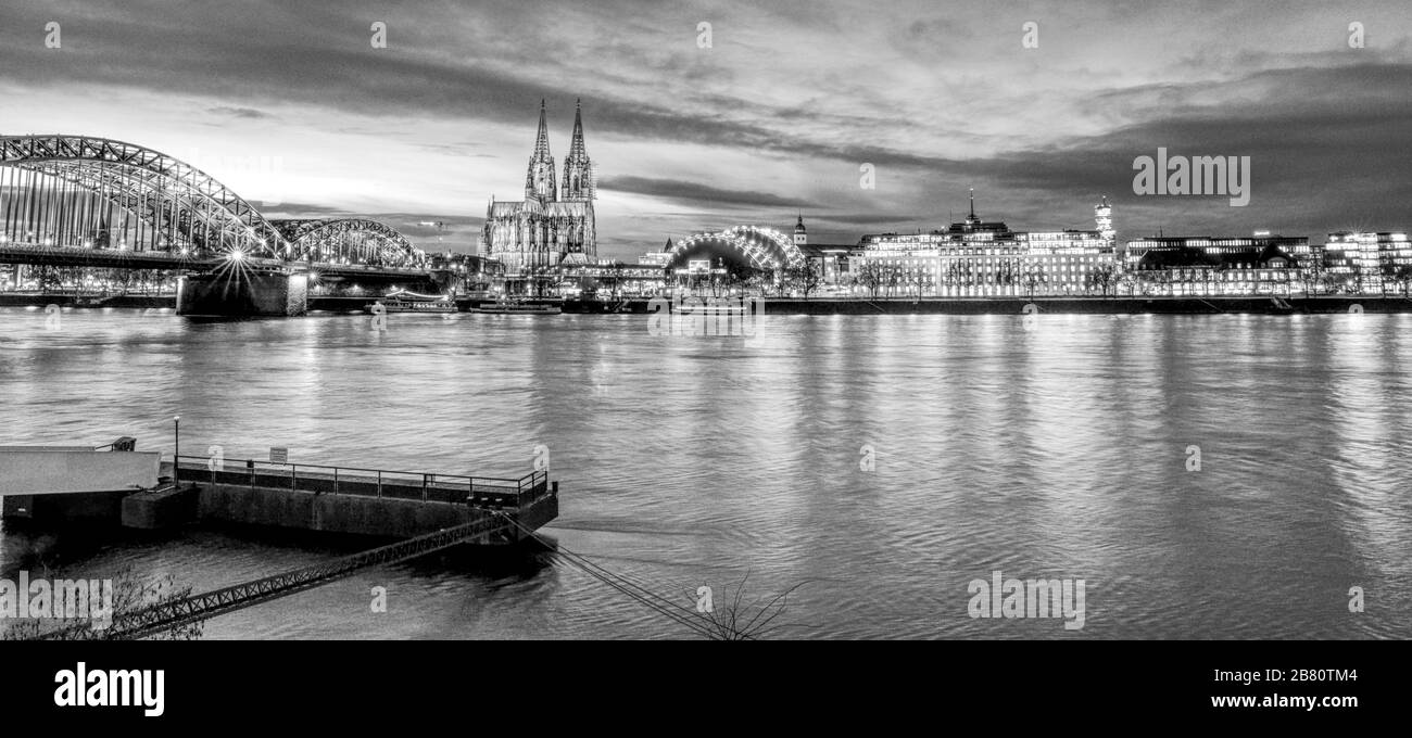 Cologne Cathedral at night from Riverside in blue hour black and white Stock Photo