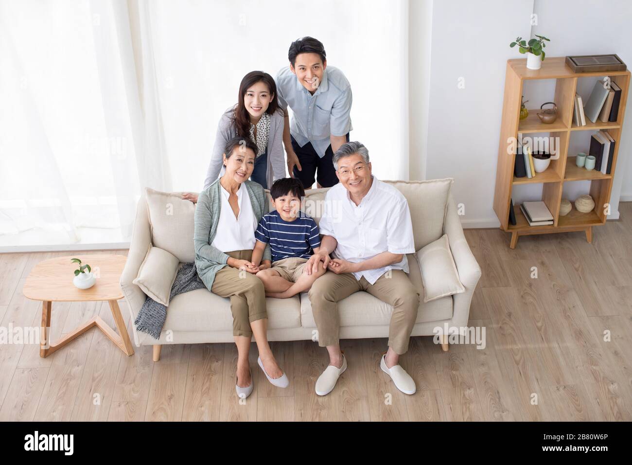 Happy Chinese family relaxing on sofa Stock Photo - Alamy