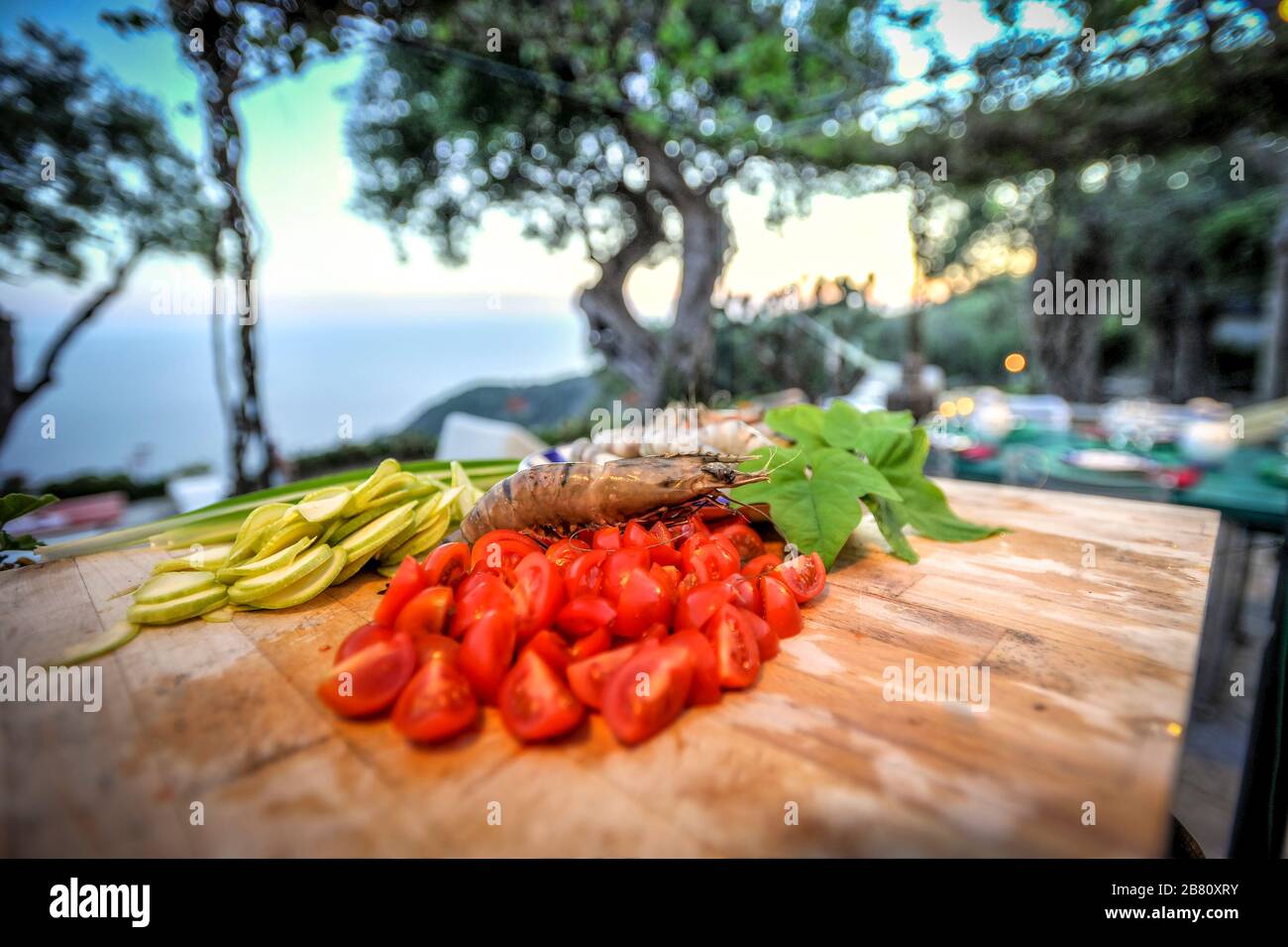 Chopped cherry tomatoes with zucchini and shrimp. Stock Photo
