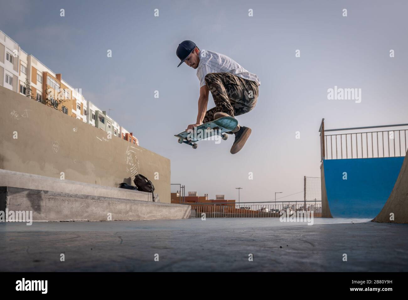 young skateboarder does a trick called boneless on the ground Stock Photo -  Alamy