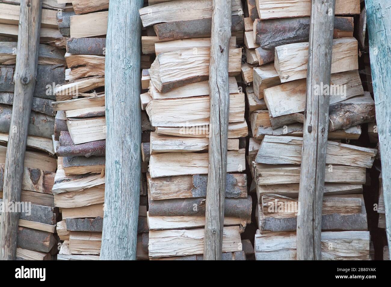 A pile of firewood for poles backed Stock Photo Alamy