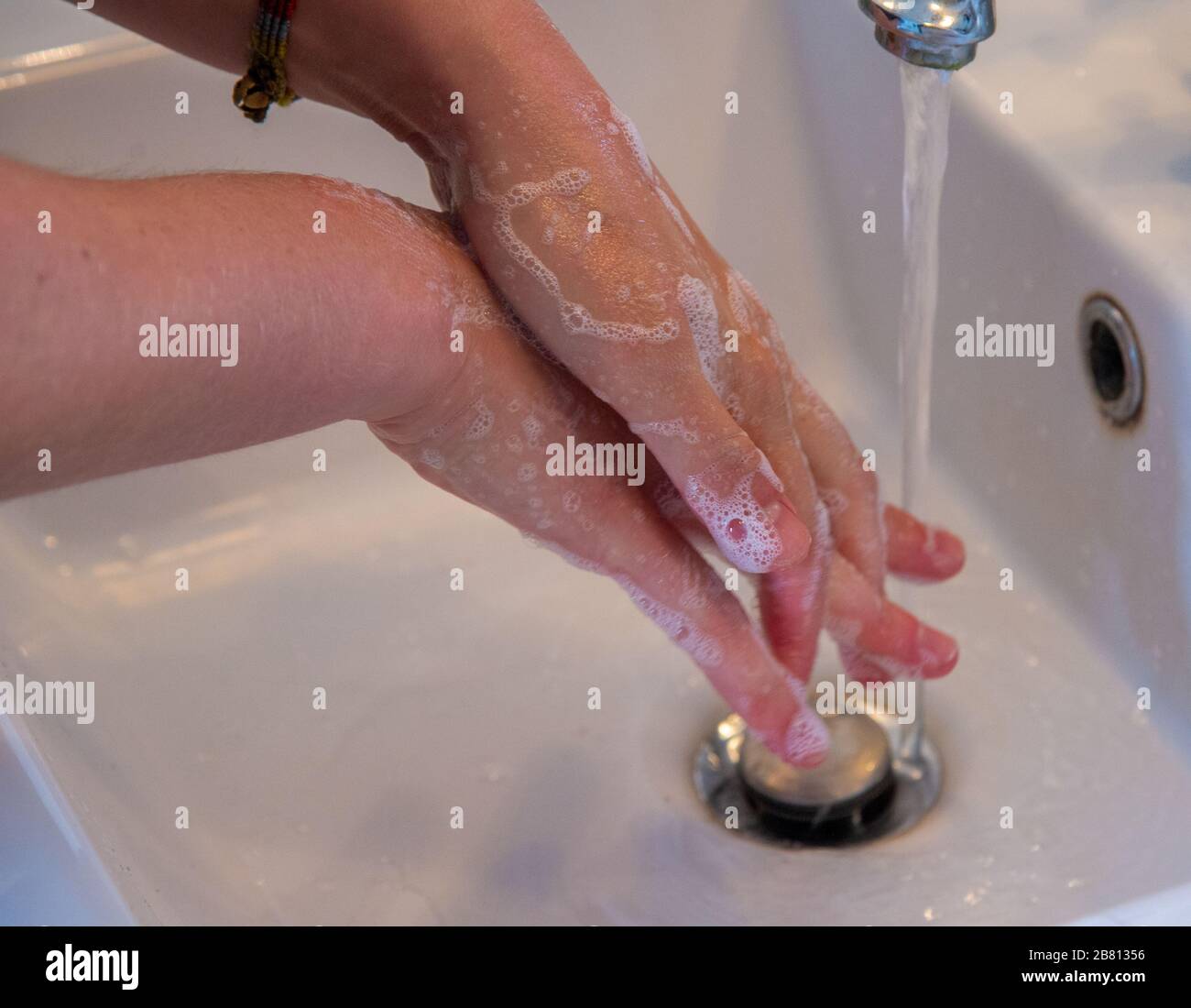 woman wash her hands in bathroom Stock Photo
