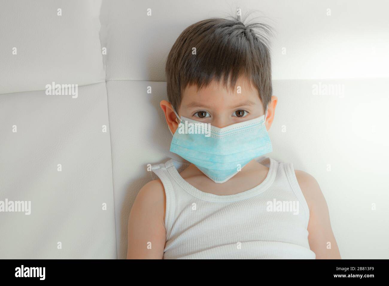 little boy with face mask looking at camera with white background Stock ...