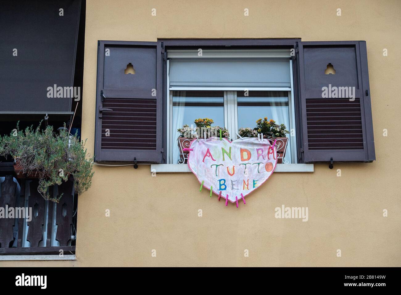 Solidarity banners have appeared on many windows and balconies of houses in the popular Garbatella district in Rome, Italy, in the fight against the Coronavirus epidemic that has hit the country heavily. The phrase most often cited in these banners is 'Tutto andrà bene - Everything will be fine'. Stock Photo