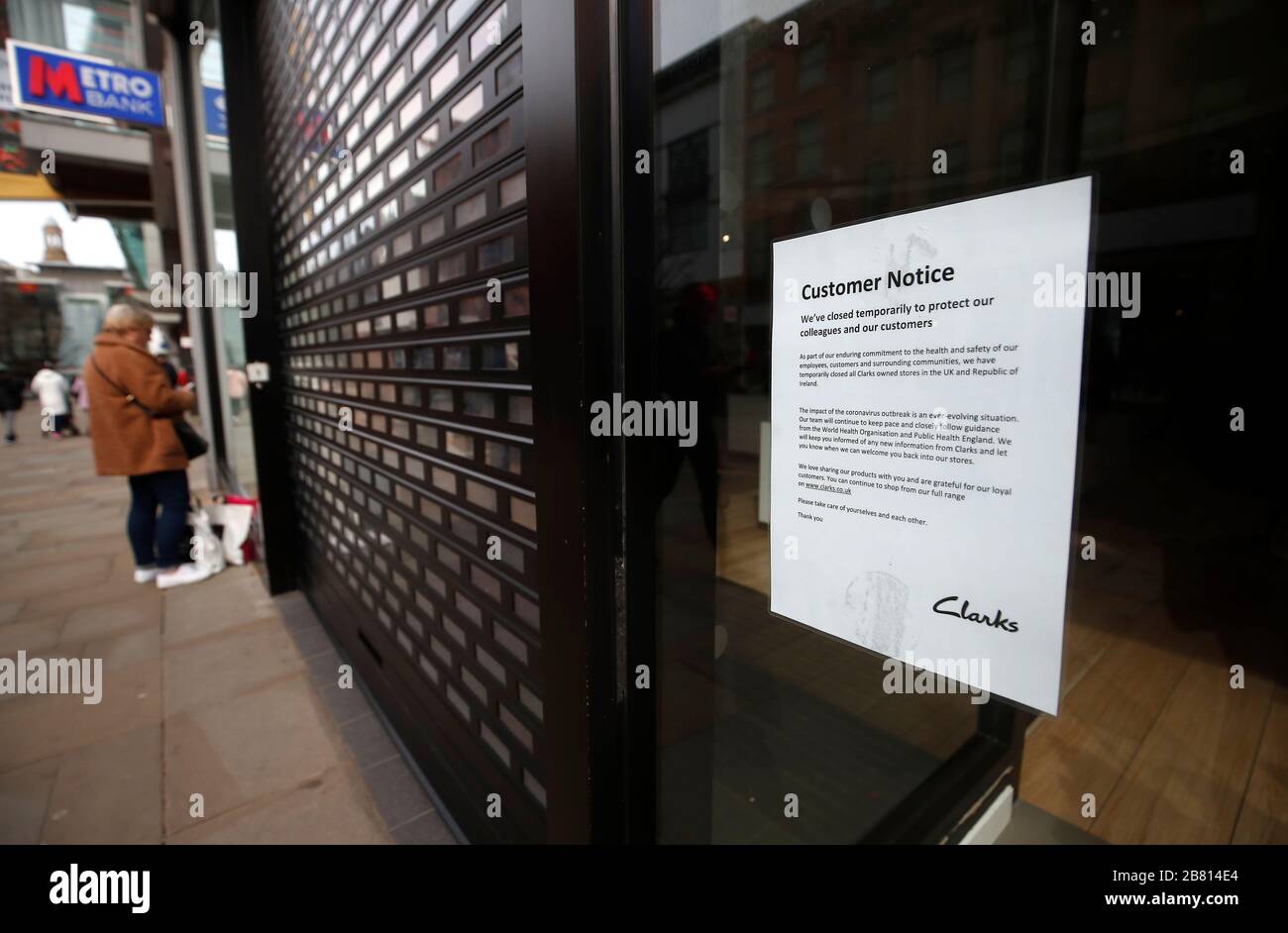 A sign in the window of a Clarks store on Market Street in Manchester notifying customers of their closure due to Coronavirus, NHS England announced that the death had