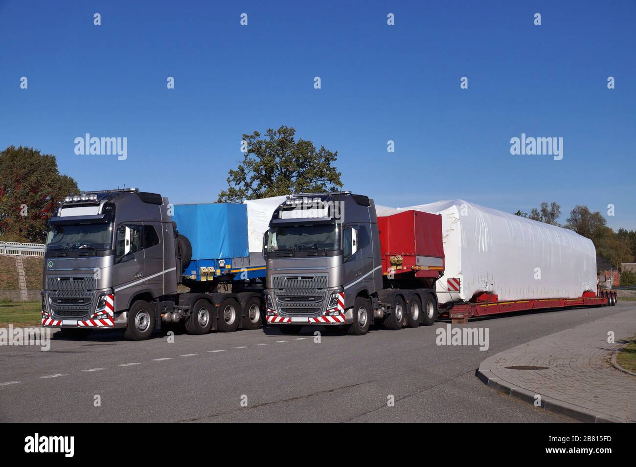 A truck with a special semi-trailer for transporting oversized loads. Oversize Load or exceptional convoy. Stock Photo