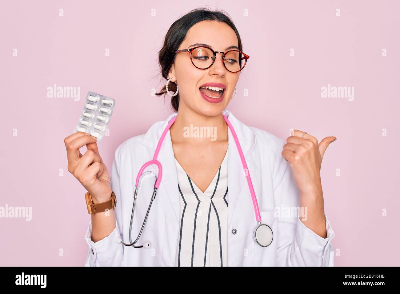 Young beautiful doctor woman with blue eyes wearing stethoscope holding ...