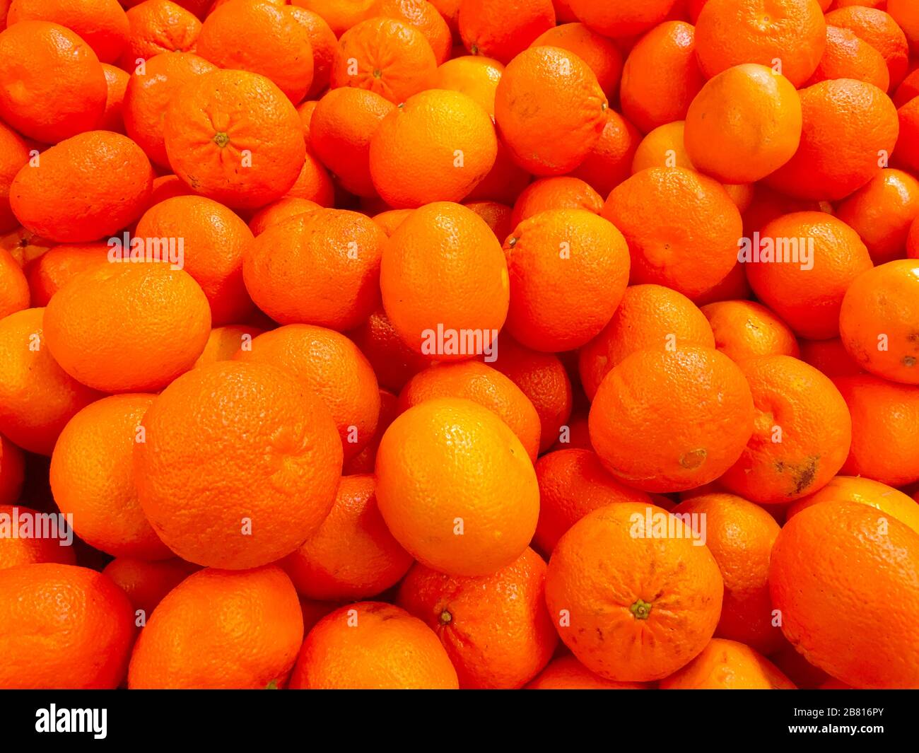 Fresh ripe mandarin oranges (clementine, tangerine) with green leaves on  retail market display, close up, high angle view Stock Photo - Alamy