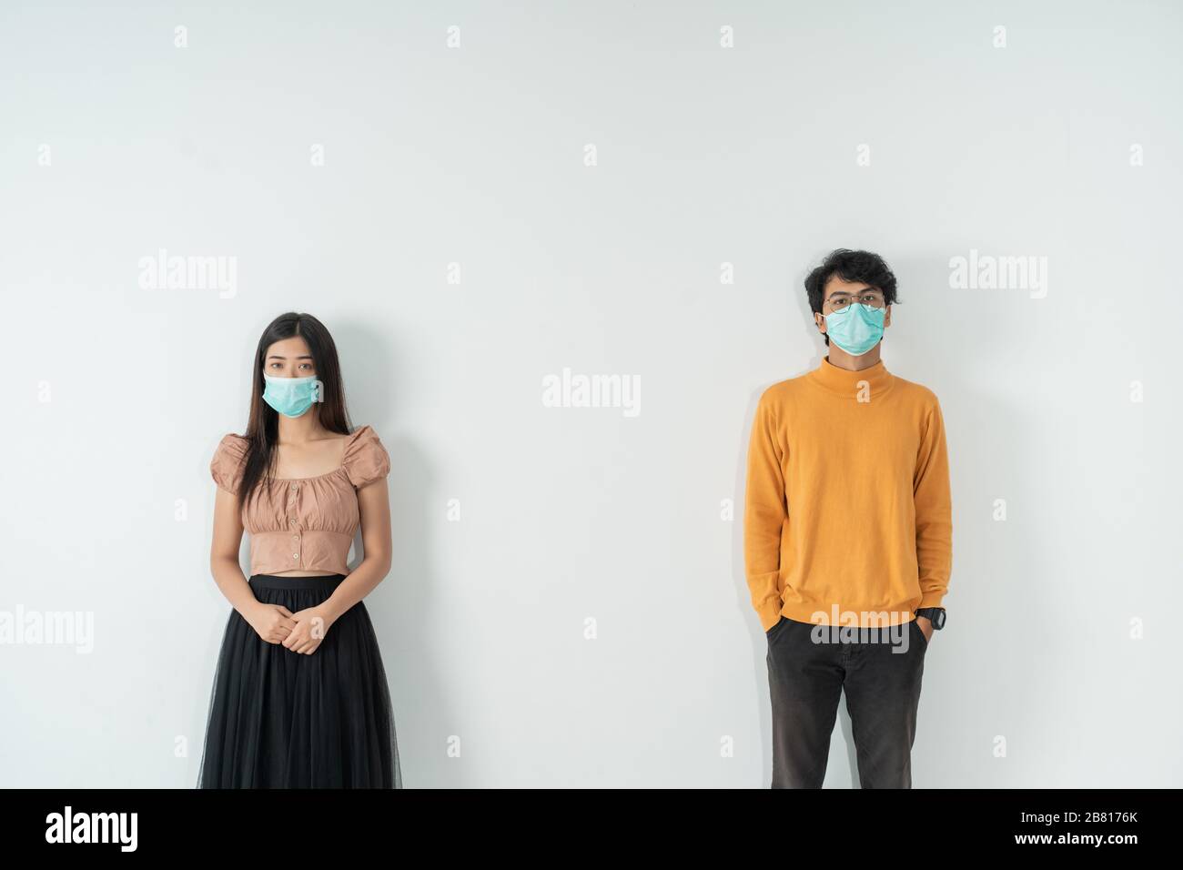 social distancing. people with masks keep their distance during virus ...