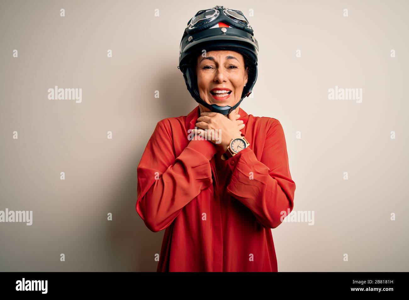 Middle age motorcyclist woman wearing motorcycle helmet over isolated
