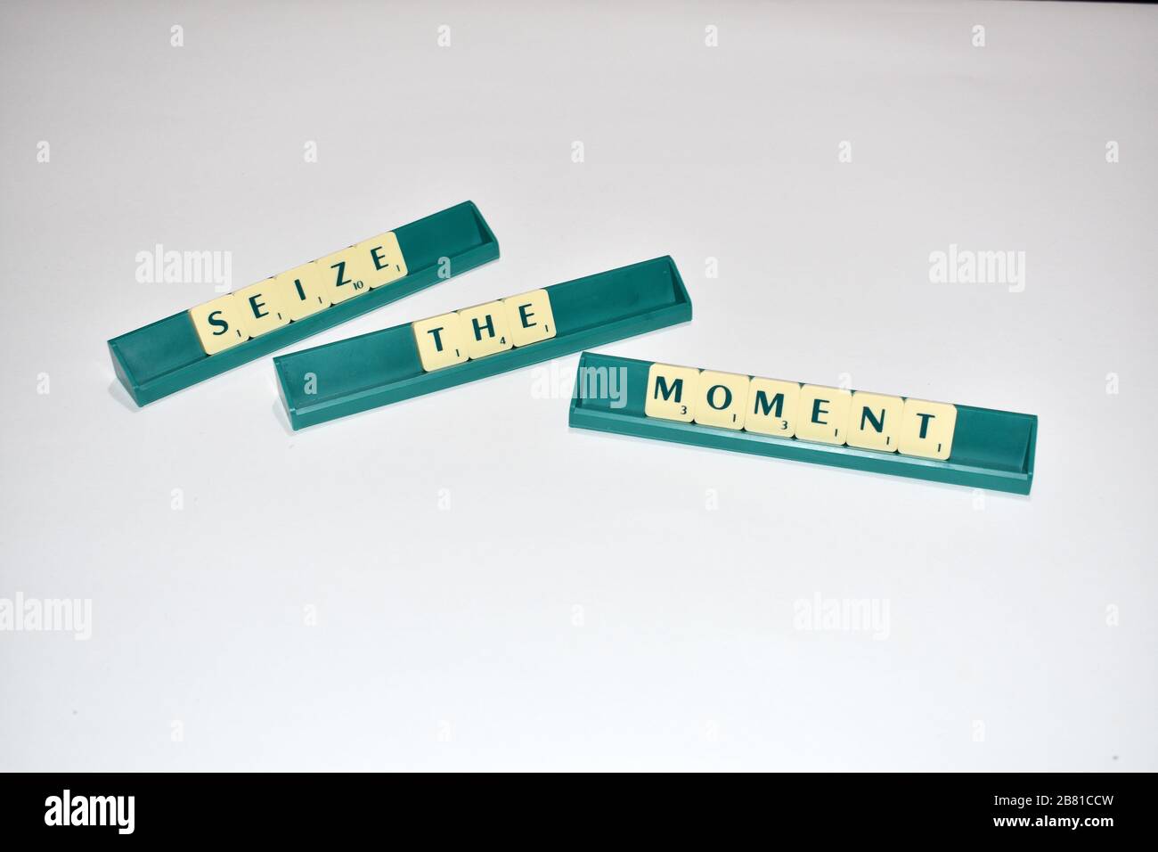 Scrabble tiles spell out Seize the Moment Motivational quote Scrabble Blocks Letters Grey Background Life quote Induce Alphabet. Stock Photo