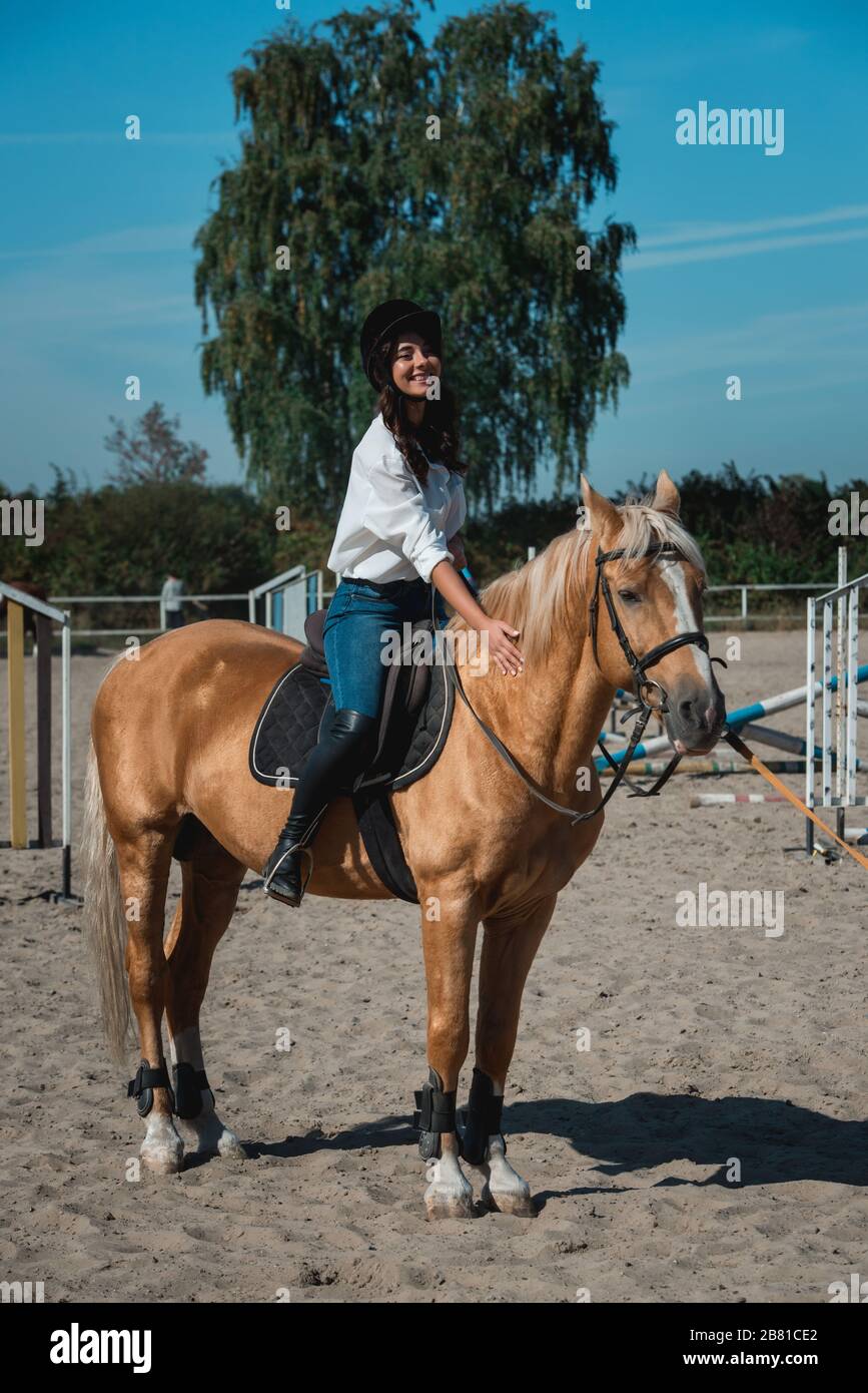Female riding black horse in hi-res stock photography and images