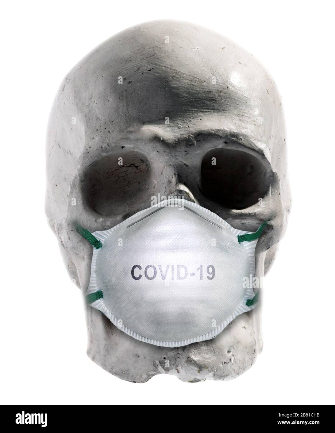 Human skull wearing a Covid-19 surgical face mask in a dire warning that the viral disease can be fatal to people isolated on white Stock Photo