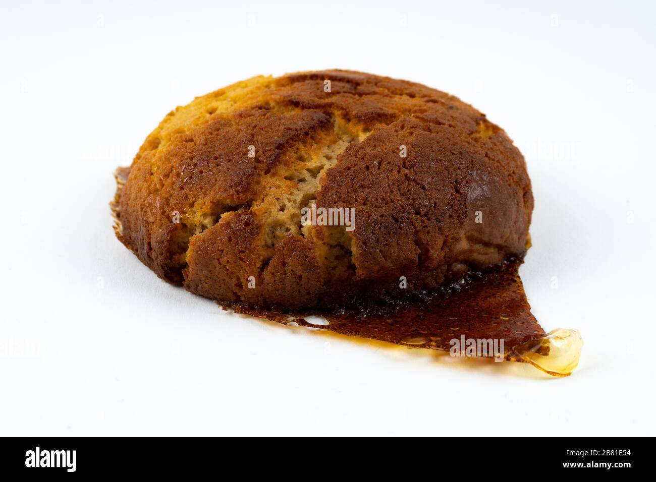 A cookie cake with peanut butter and caramel on white background with copy space - angled view Stock Photo