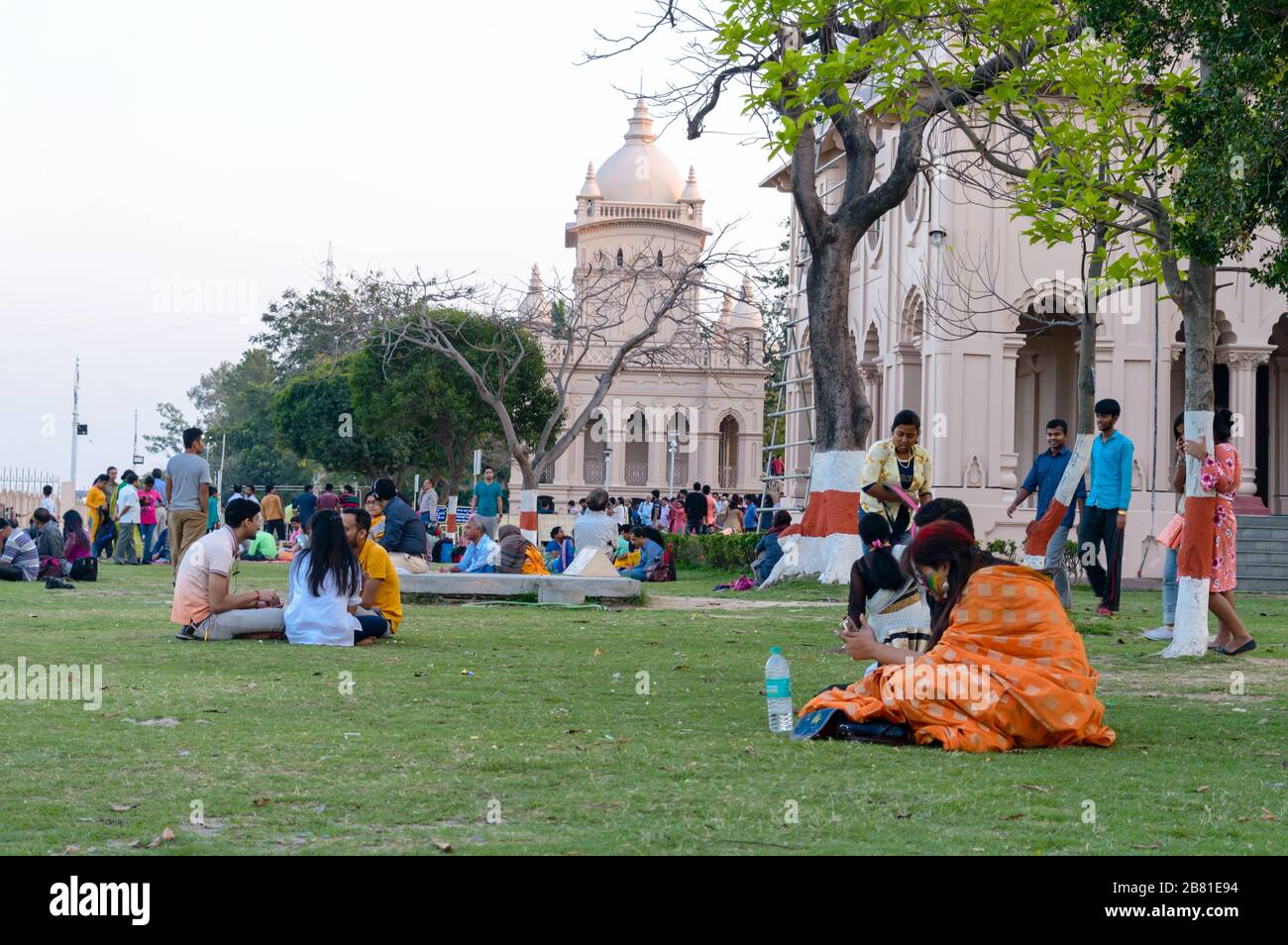 Large group of tourists people sitting on the lawn area and spending Holiday time in sunset time. Beluṛ Maṭh Ramakrishna Swami Vivekananda Mission. Ko Stock Photo