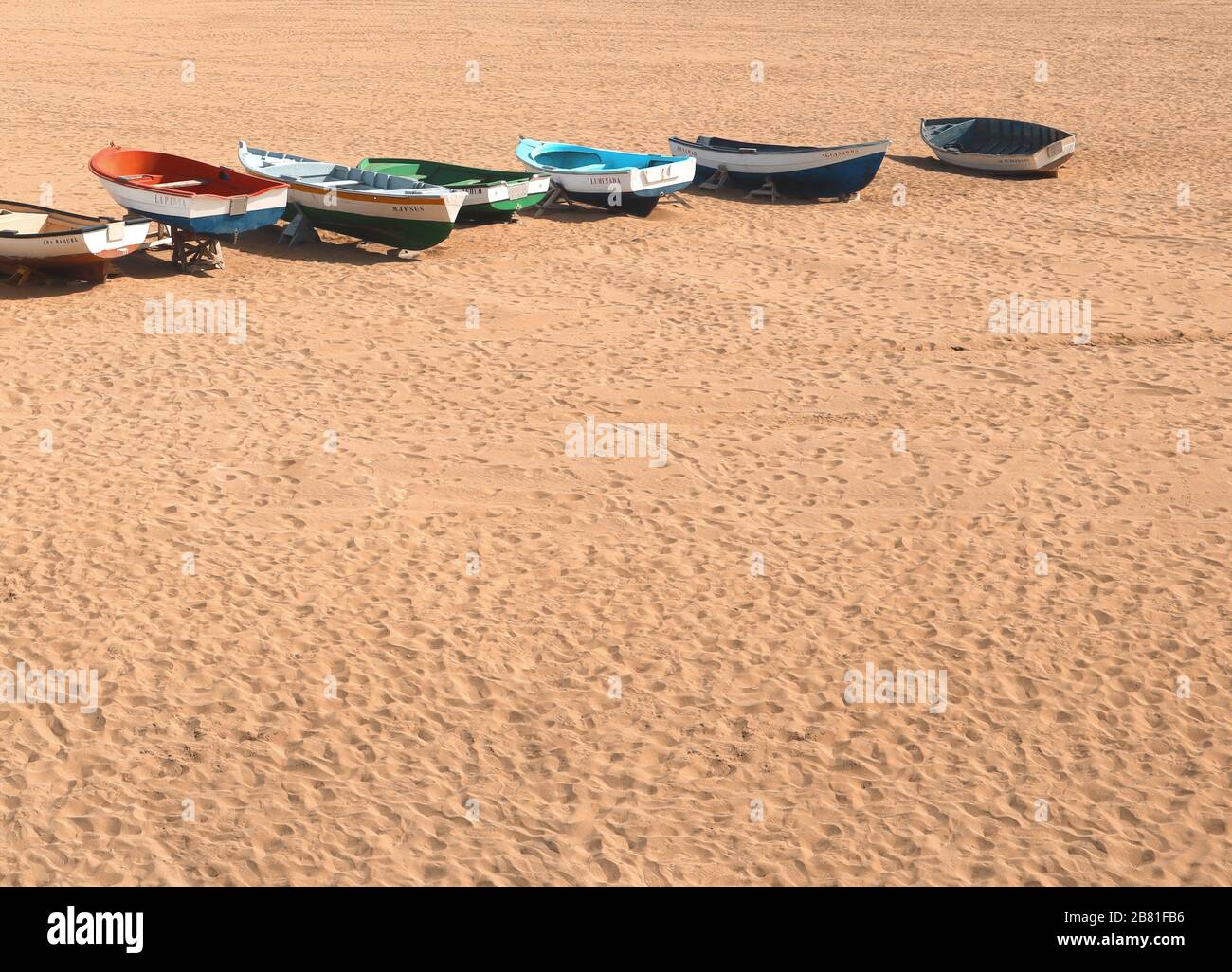 Abandoned fisherman boats on a desert beach Stock Photo