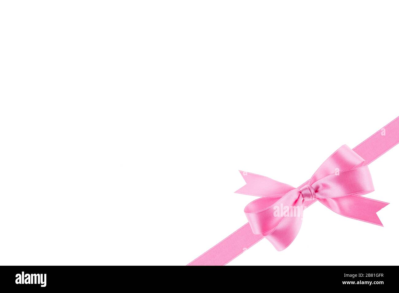 Pink ribbon with a bow on white background Stock Photo - Alamy