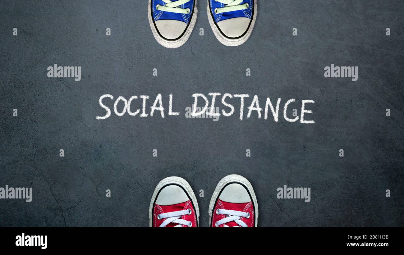 Social distance. two people keep spaced between each other for social distancing, increasing the physical space between people to avoid spreading illn Stock Photo