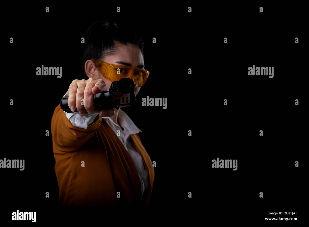 A hand holding gun and pointing it at camera hires stock photography