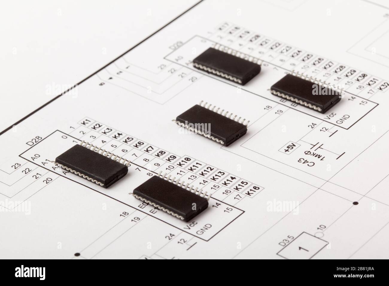 Closeup photo of microcircuit chips on drawing of an electronic device ...