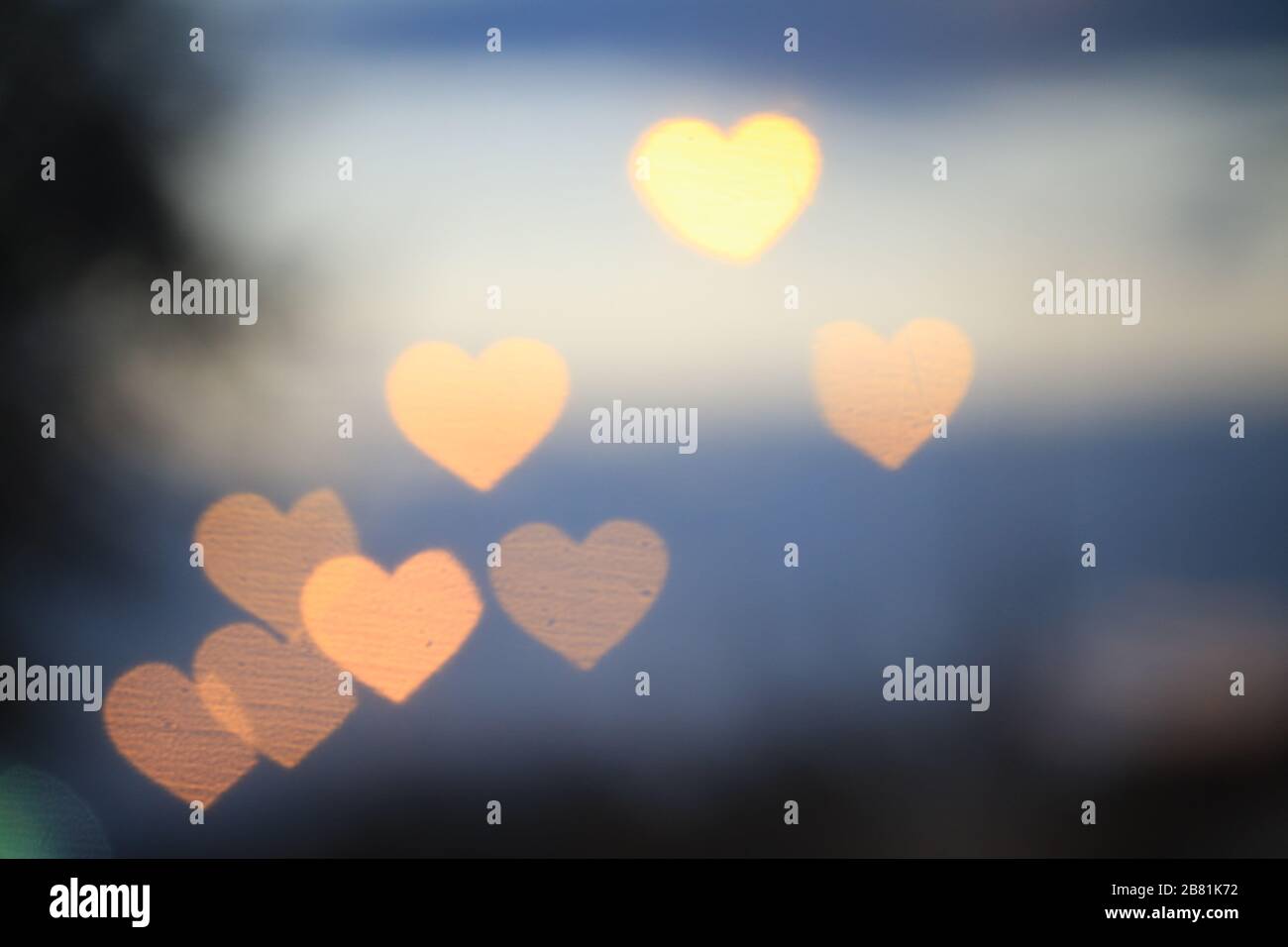 Yellow gold heartshaped on black background Colorful lighting bokeh