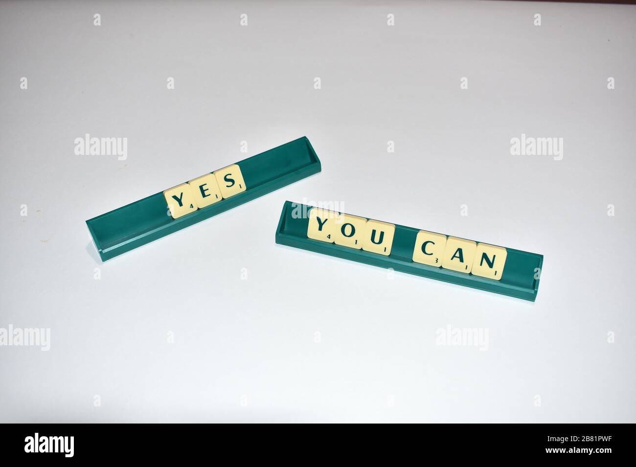 Scrabble tiles spell out Yes You Can Motivational quote Scrabble Blocks Letters Grey Background Life quote Induce Alphabet. Stock Photo