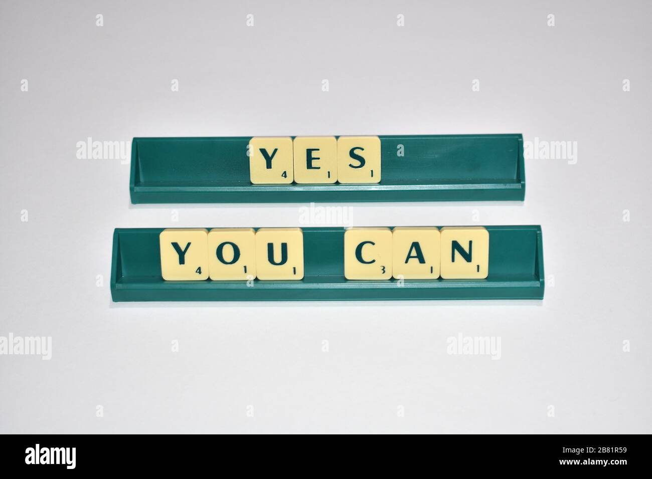 Scrabble tiles spell out Yes You Can Motivational quote Scrabble Blocks Letters Grey Background Life quote Induce Alphabet. Stock Photo