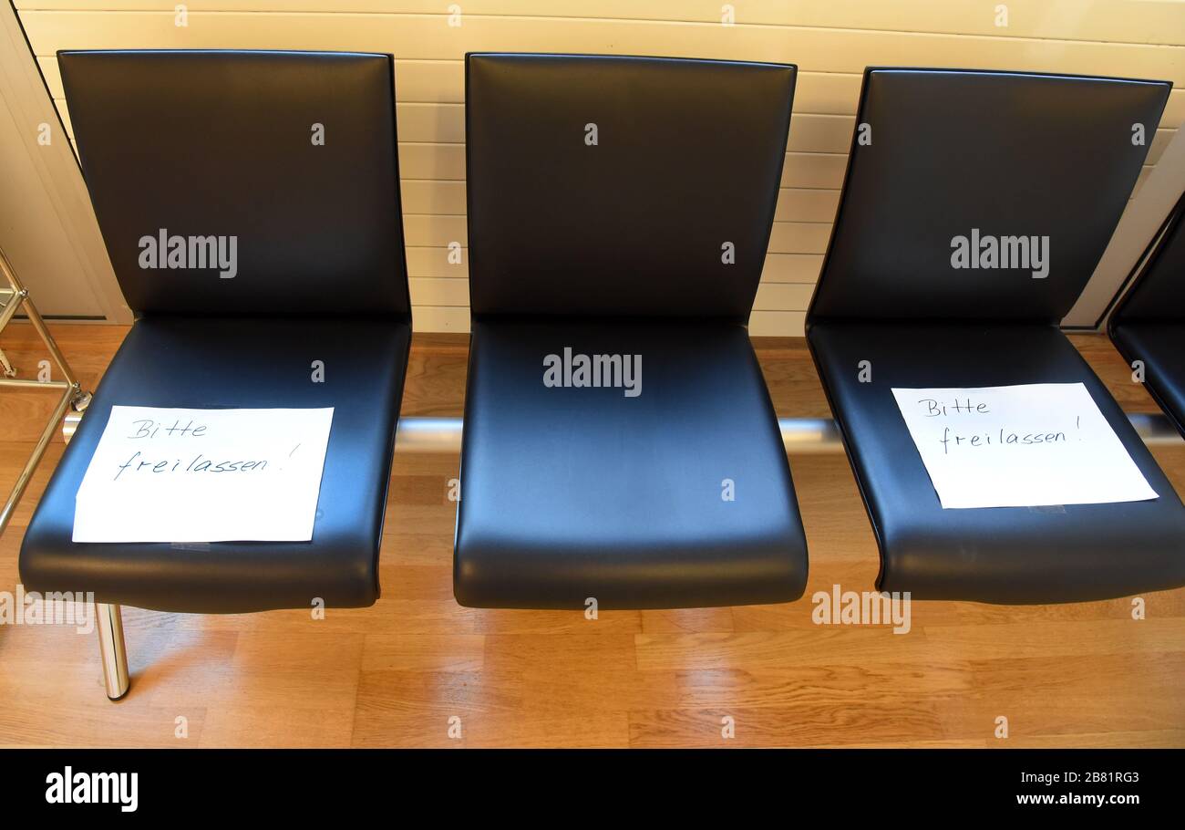18 March 2020, Saxony, Leipzig: In a waiting room of a radiological clinic in the centre of Leipzig, every second chair has slips of paper on it with the note 'Please keep your hands free' and a warning that people should not greet each other with a handshake. Due to corona, this is intended to keep a minimum distance between patients and reduce germs. Photo: Waltraud Grubitzsch/dpa-zentralbild/ZB Stock Photo
