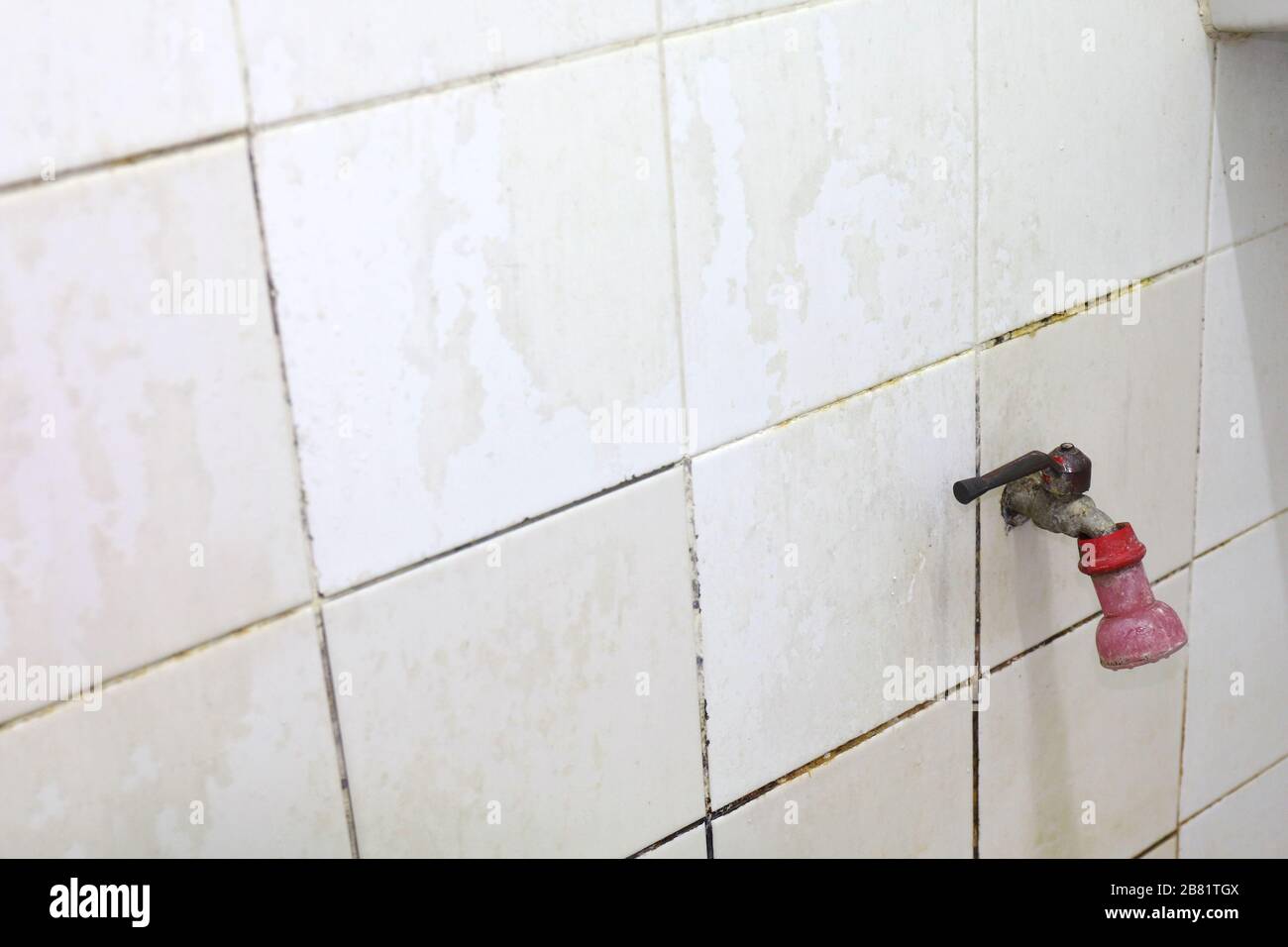 old water tap in bathroom old faucet on a bathroom wall Stock Photo - Alamy