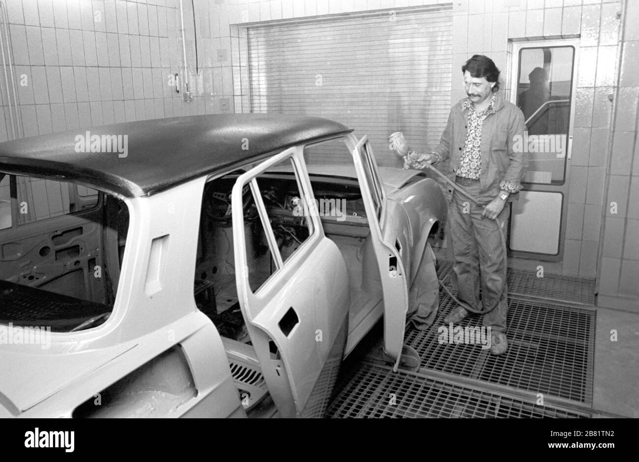 30 November 1988, Saxony, Torgau: In a car paint shop in Torgau, cars Skoda (in the picture) and Trabant are prepared for repainting in 1989. Exact date of taking the picture not known. Photo: Volkmar Heinz/dpa-Zentralbild/ZB Stock Photo
