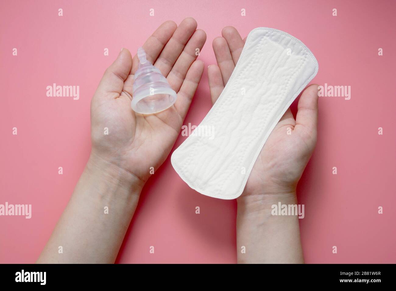 Hands holding menstrual hygiene products. Menstrual cup and sanitary pad.  Zero waste alternative, choise concept Stock Photo - Alamy