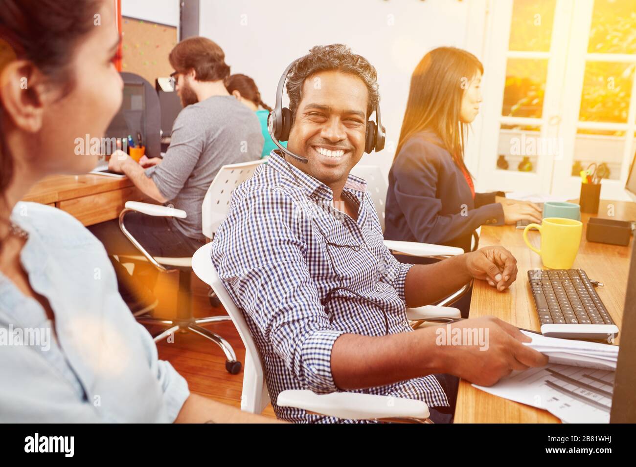Customer advice and support in the Indian call center with Indian with headset Stock Photo