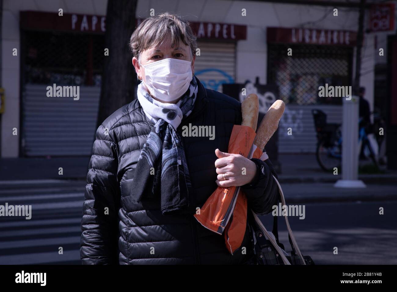 Maria Dolores wears a face mask as a precaution against the spread of Coronavirus in Paris.Ministry Health France has recorded a total of 7,730 infections, 175 death and 602 recovered since the beginning of the outbreak. Stock Photo